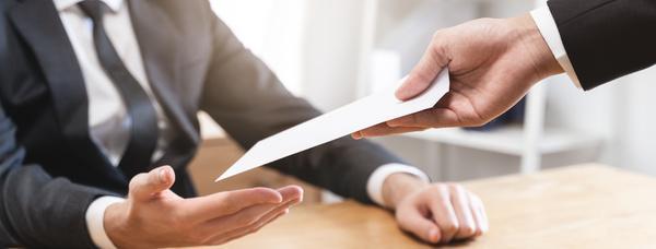 Woman handing a man an envelope