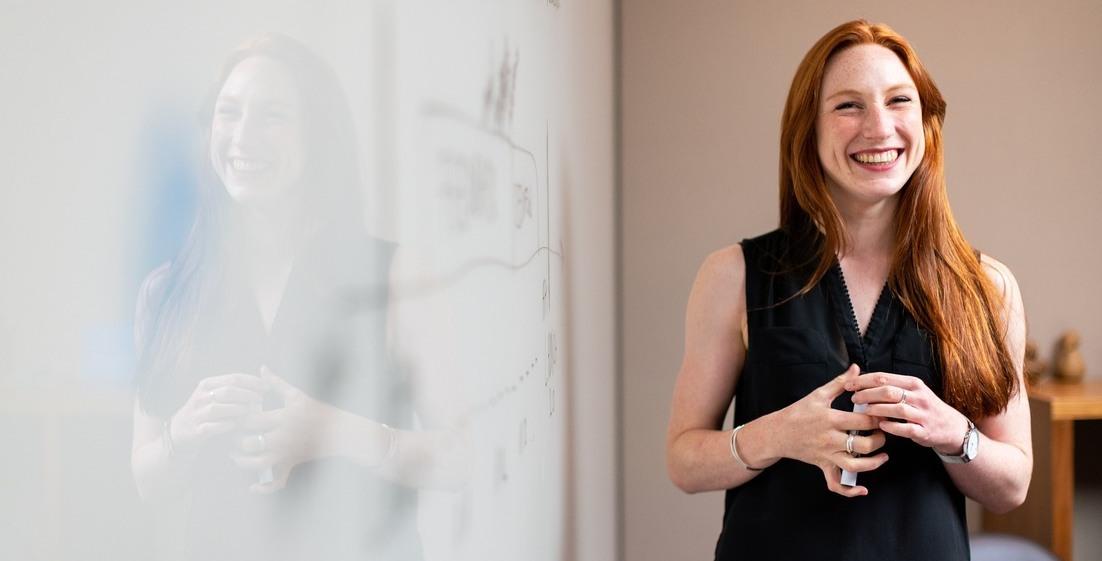 Woman next to a whiteboard