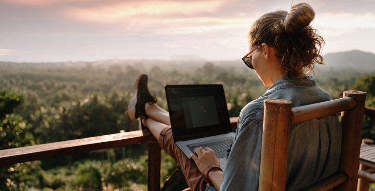 Woman on a laptop sitting outside