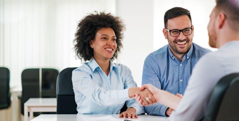 three people shaking hands after interview